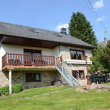 House With Beautiful Wooden Balcony Located Against The Hills *