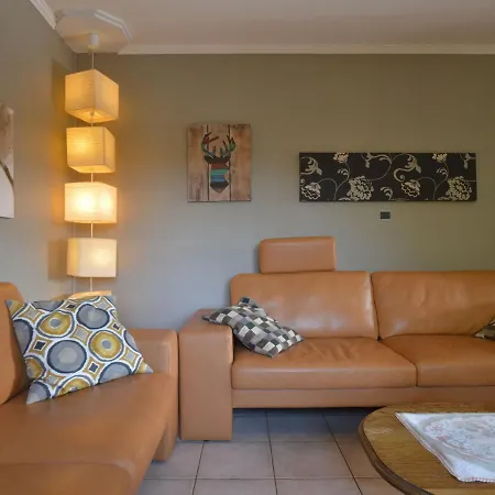 House With Beautiful Wooden Balcony Located Against The Hills Ondenval