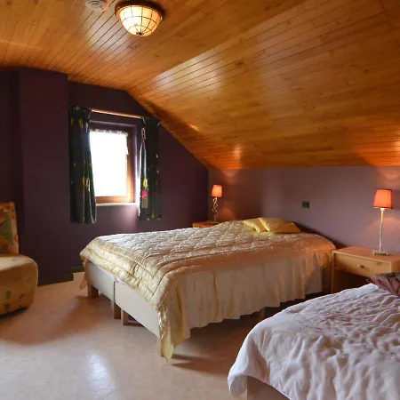 House With Beautiful Wooden Balcony Located Against The Hills *